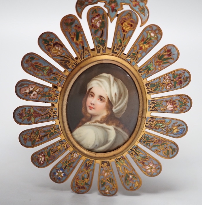 An 19th century Paris porcelain portrait miniature of a lady in a champleve enamelled frame. 13.5cm total exterior frame length